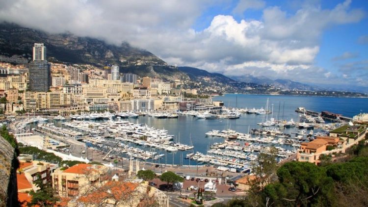 Helicopters, trains, buses, and airport shuttle vans provide fast transportation from Monaco, Monte Carlo, and Menton to Nice-Côte d’Azur Airport (NCE) - Monaco Port viewed from the Rock
