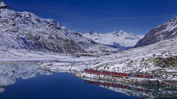 Bernina Express running beside Lake Bianco