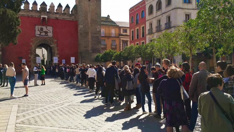 Buy tickets for the Real Alcazar online. Ticket queues outside the Real Alcazar palace complex in Seville, Spain.
