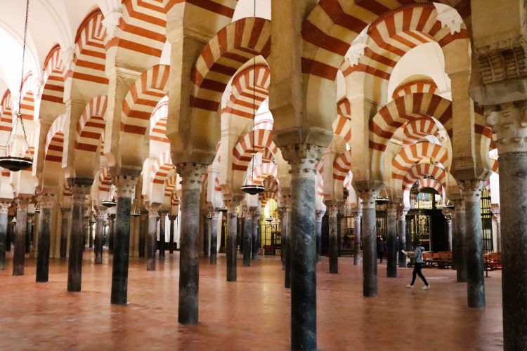White-and-red horseshoe-shaped arches in the Mezquita Mosque-Cathedral in Cordoba