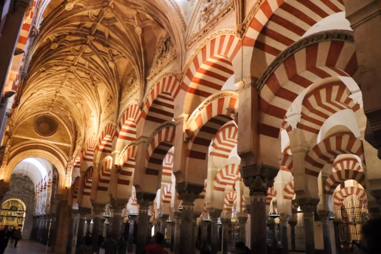 White-and-red horseshoe-shaped arches in the Mezquita Mosque-Cathedral in Cordoba