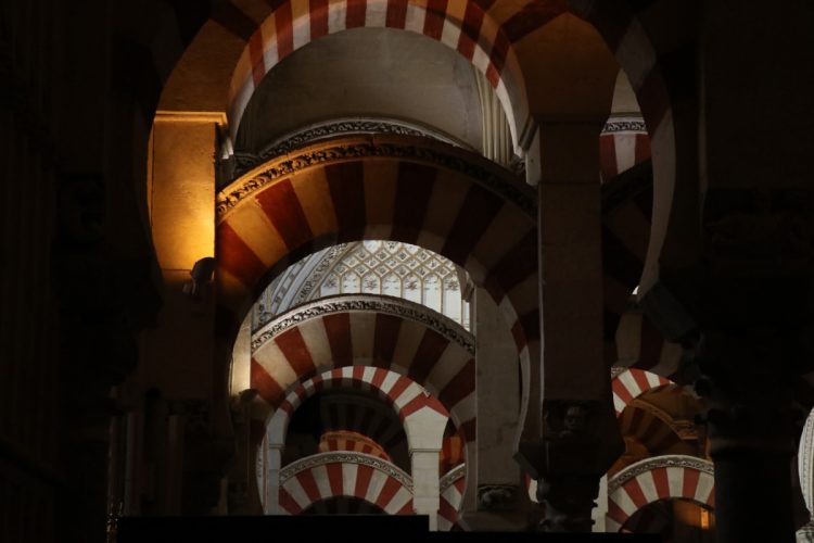 Red and white horseshoe-shaped arches in the Mezquita Mosque-Cathedral in Cordoba