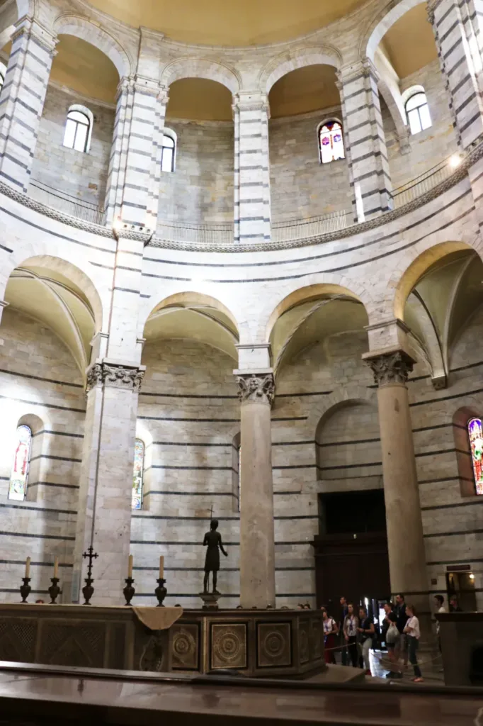 bronze statue of John the Baptist at the center of the baptismal font in Pisa's magnificent baptistery