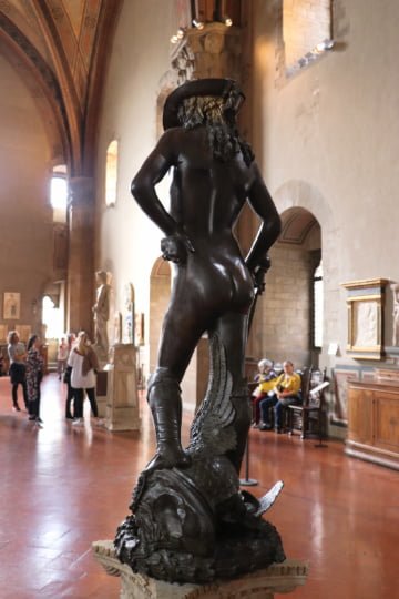 Donatello's Bronze David (1440) in the Bargello seen from the rear with marble David in the background
