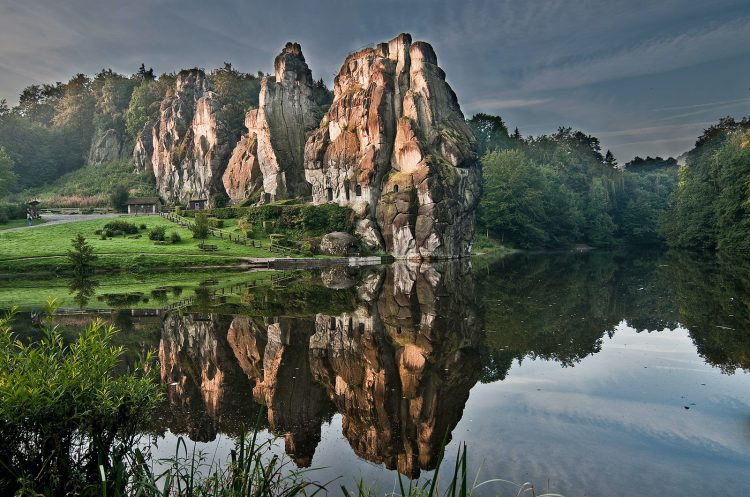 Externsteine reflected in the water of the artificial pond
