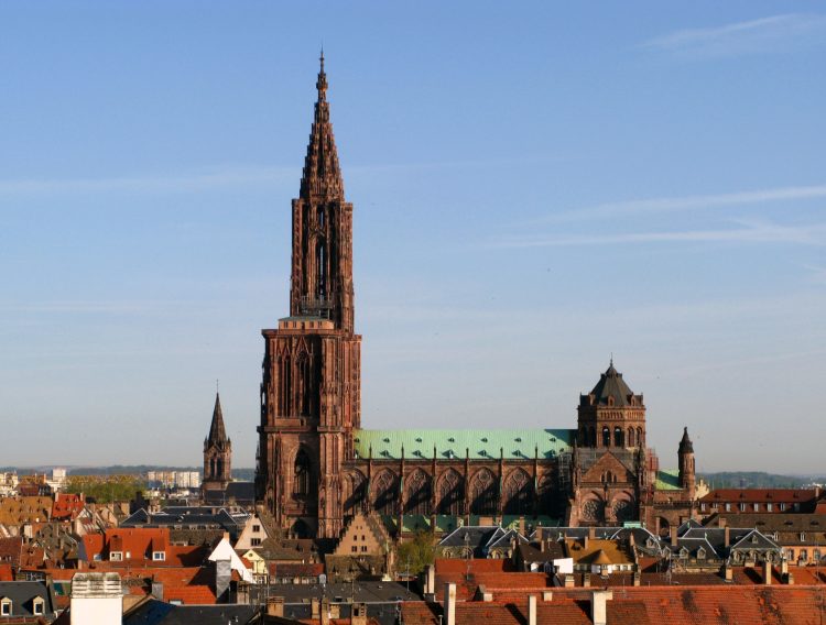 The High Gothic Strasbourg Cathedral (Cathédrale Notre Dame) in Alsace, France is a single-tower church with medieval stained-glass windows and an impressive astronomical clock.