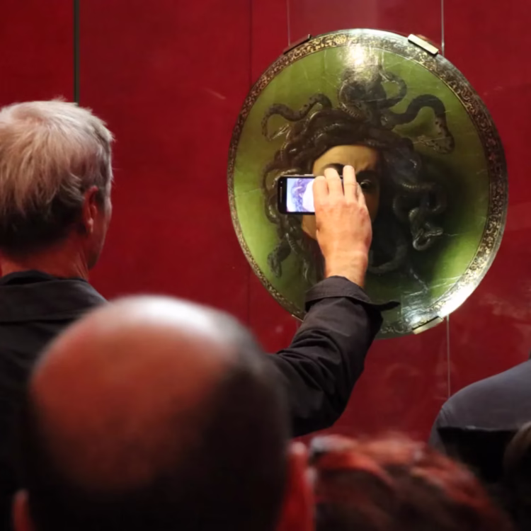 Caravaggio's Medusa and phone camera screen in the Uffizi in Florence