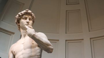 Close up of the head and upper torso of Michelangelo's David in the Accademia