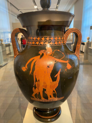 An amphora of Satyrs with musical instruments and Hermes on the way to a symposium by the “Berlin Painter” on display in the Altes Museum in Berlin