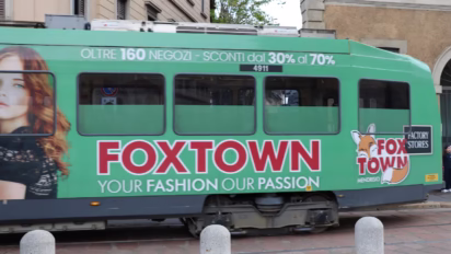 Foxtown factory stores outlet mall advertising on a tram in Milan