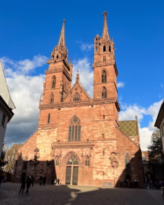Sunlit western facade of Basel Minster (Basler Münster) in Switzerland