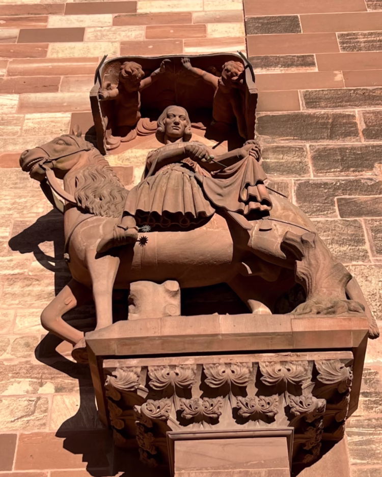 Sculpture on the Basel Minster of St. Martin of Tours dividing his mantle to share with a beggar.