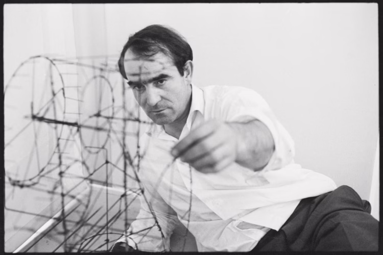 black and white photo of the Swiss artist Jean Tinguely with Moulin à Prière displayed in the Museum Tinguely in Basel.