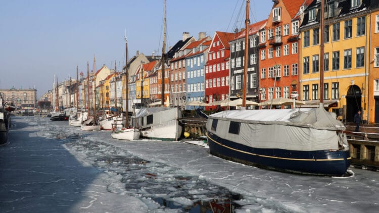 Colorful houses and buildings of Nyhavn in Copenhagen with Frozen Canal